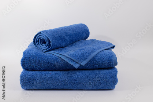 Blue terry towel folded isolated on white background