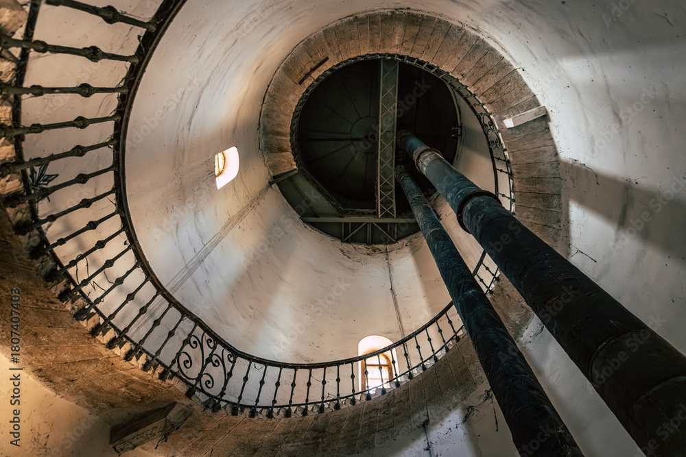 Obraz premium Inside the Historic Water Tower with Riveted Steel Tank, Spiral Staircase, Preserved Industrial Heritage in Komarno, Komarom, Slovakia