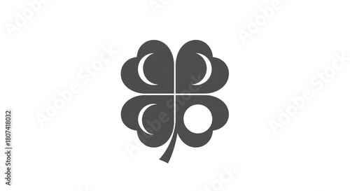 Stylized graphic icon of a dark gray four-leaf clover with stylized inner shapes symbolizing luck and fortune on a white background
