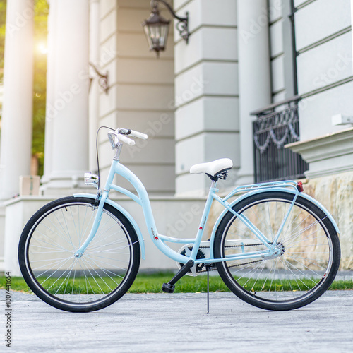 Side view of a modern city urban city bike or bicycle for street road. City bicycle parked on a lawn. Urban bike standing upright on grass, static, no people.