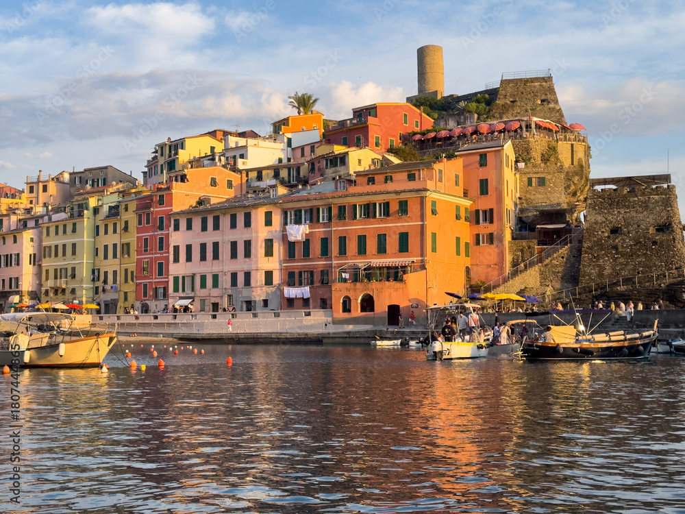 Obraz premium Colorful Coastal Italian Harbor Town Boats Waterfront Historic Fortress Sunset