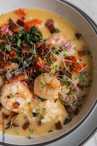 gourmet shrimp and grits in shallow bowl