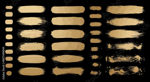 Collection of golden brush strokes and lines on a black background, perfect for graphic design and artistic projects