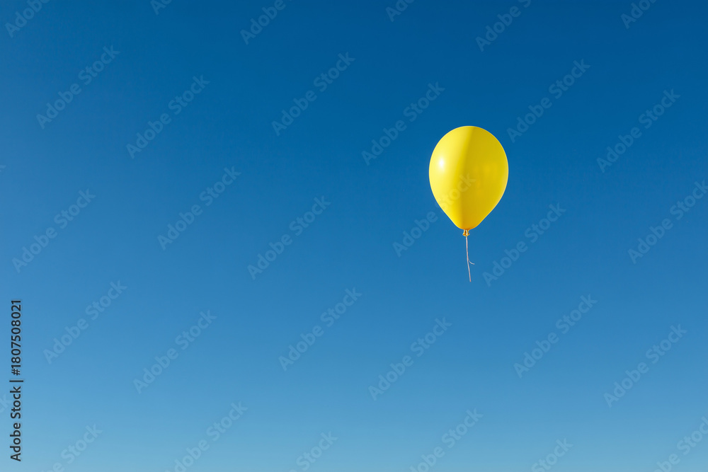 Obraz premium Yellow balloonon blue sky. Minimal concept.