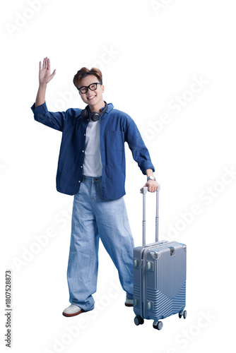 Ready to Explore: A young traveler cheerfully waves goodbye while holding his luggage, a beacon of adventure and wanderlust.