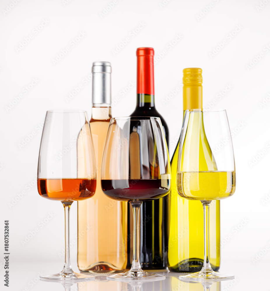 Naklejka premium Different wine bottles and glasses on white background