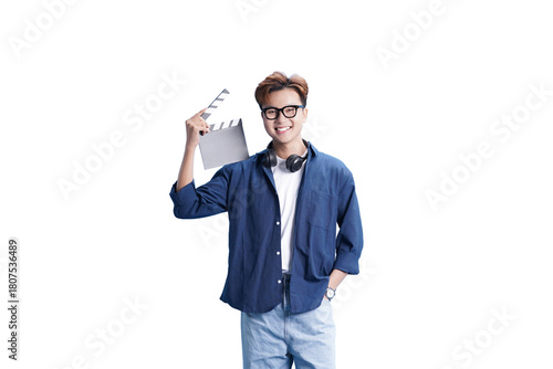 The Smiling Filmmaker : A young, confident filmmaker stands ready on set, holding a clapboard and headphones. Capturing the spirit of movie magic, ready for action!