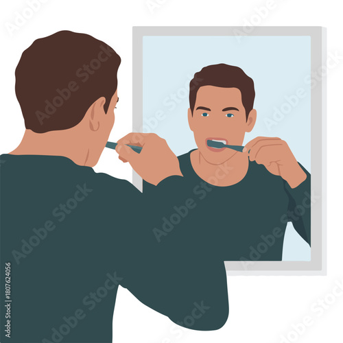 Man brushing his teeth in front of a mirror isolated on