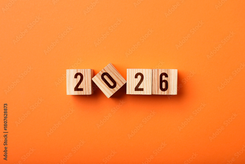 Obraz premium New 2026 year. Cubes with numbers on orange background, top view