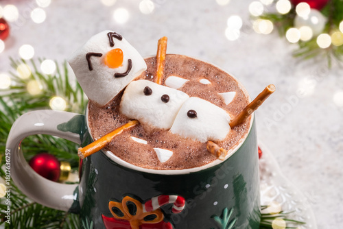 Fun holiday hot chocolate with marshmallow snowman enjoyed by the cozy fire