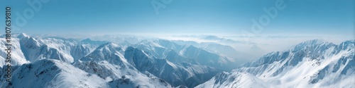 Vast snowy mountain range under clear blue sky