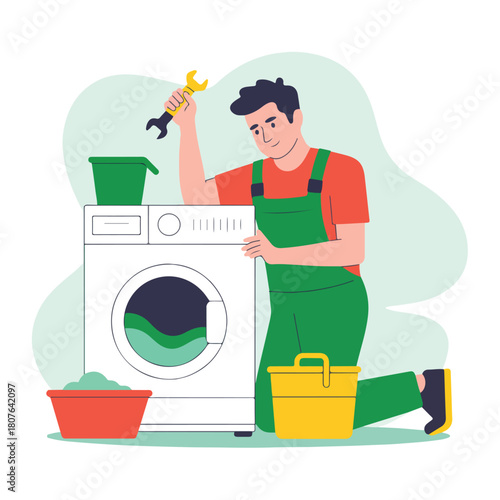 Man in green overalls repairing a washing machine isolated on