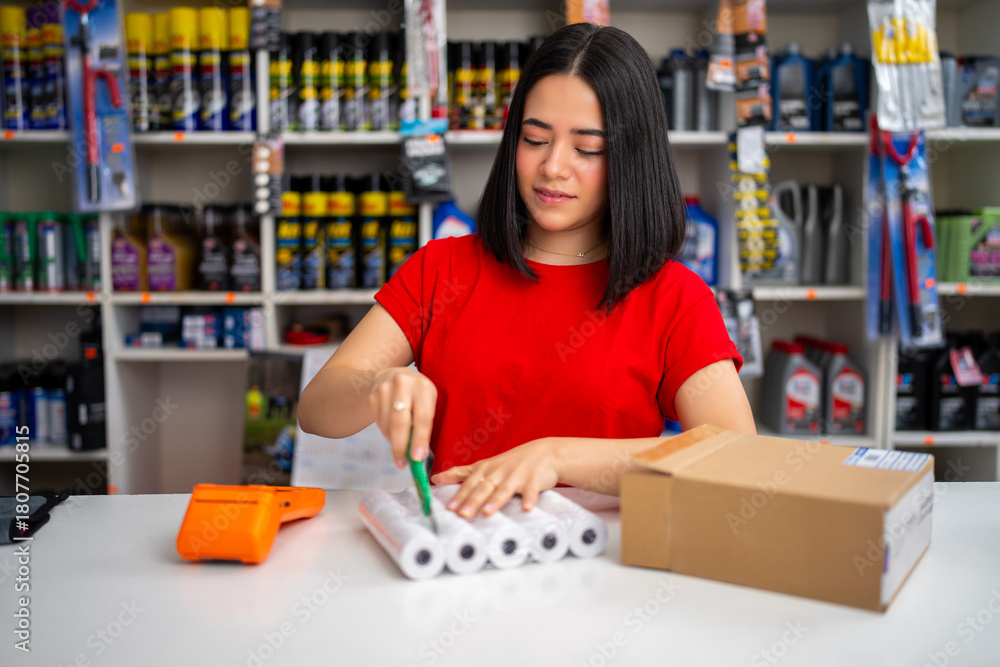Fototapeta premium Woman worker preparing products for online order delivery in an auto parts shop