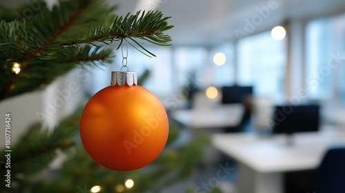 Festive office decor with orange bauble on christmas tree branch