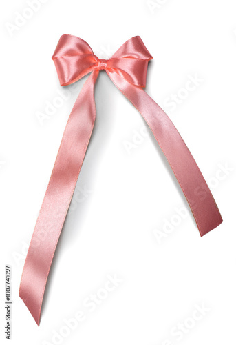 Bow ribbon Pink satin gift bow isolated on white background. Holiday decoration silk ribbon, top view. Pastel color gift design. Vertical image
