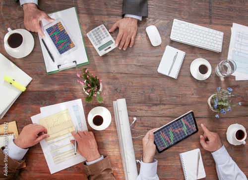 many businessman hands on meeting table. 