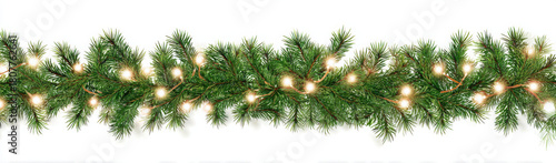 A festive green Christmas garland with glowing warm white lights, isolated on a white background to be used as a border.