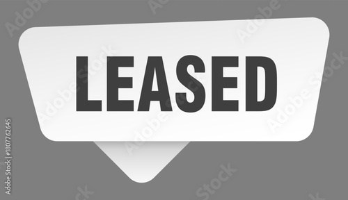 leased sign. leased white sticker isolated on gray background