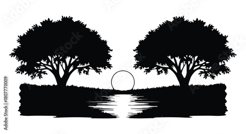 Serene landscape with silhouetted trees framing a setting sun over calm water.