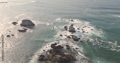 Aerial drone footage of the Cantabrian Sea on the Asturias coast during a colorful sunset. 