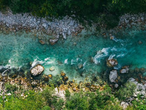 Aerial View of Turquoise River and Rocky Shore