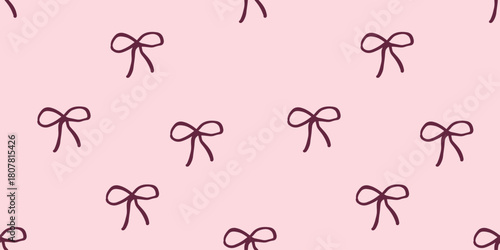 Seamless pattern with hand-drawn ribbon bows on a light pink background