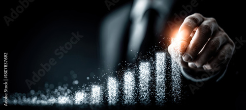 Businessman hand creating glowing bar chart growth