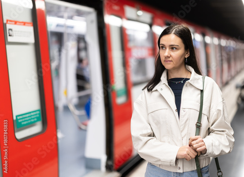 Photography Female passenger awaits the metro train at the arrival station