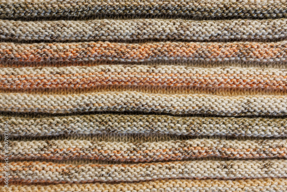 Fototapeta premium Knitted Fabric Texture with Warm Multicolor Stripes, Close-Up Background