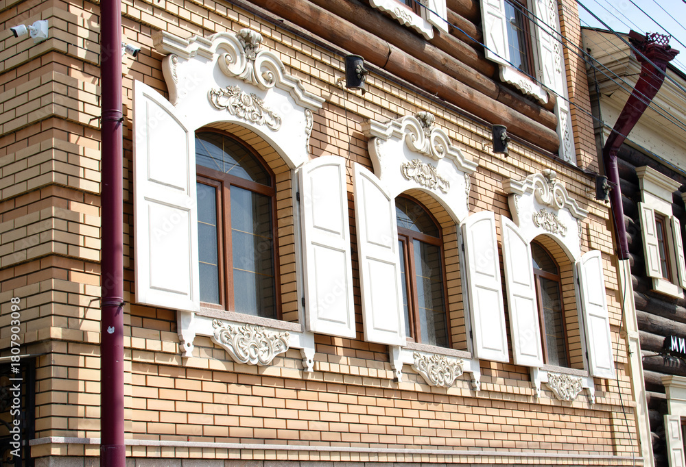 Obraz premium Decorative antique plaster on the facade of the building above the window