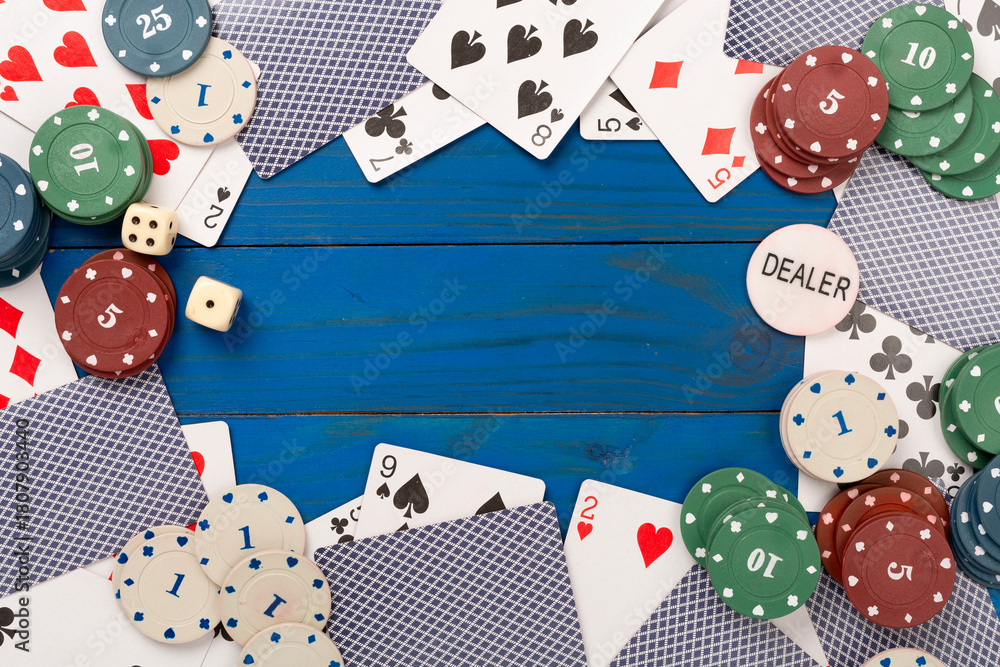 Obraz premium Poker chips and playing cards on wooden background, top view. Casino card game