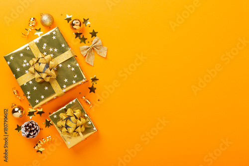 Golden gift boxes and decor on color background, top view