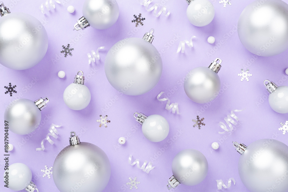 Fototapeta premium Grey Christmas balls with decor on color background, top view