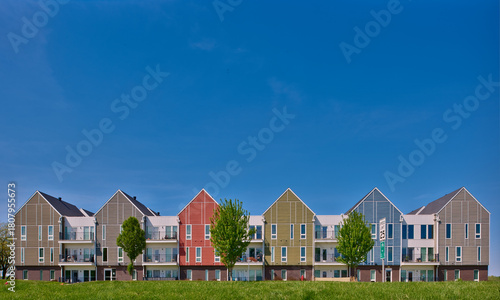Apartments,condominiums, green space and bike paths in an area of urban expansion. Solutions for more housing. Colorful buildings and blue sky.