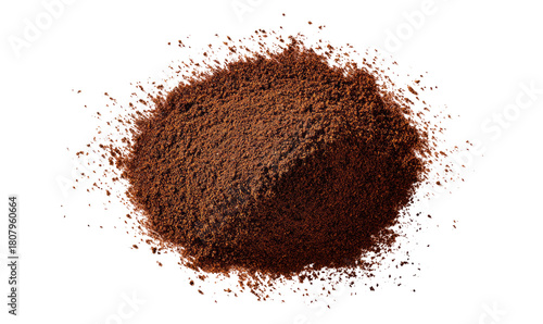 Dark brown powder pile, top-down view.  Scattered particles surround the central mound