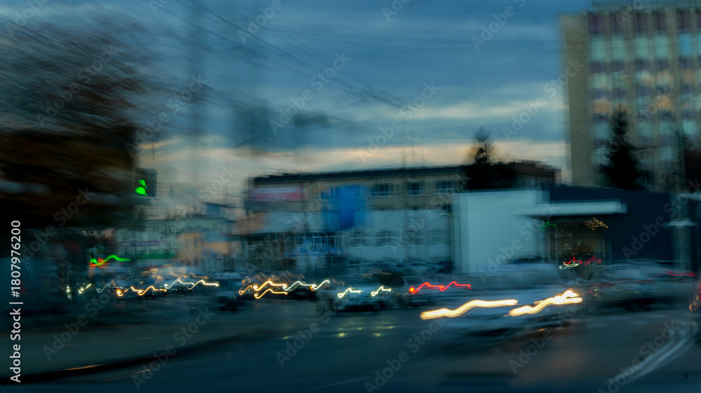 Obraz premium Abstract cityscape with blurred lights and buildings at dusk