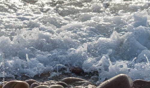 Fototapeta Naklejka Na Ścianę i Meble -  Sea Waves Creating White Foam Between Coastal Stones