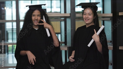 Two teenage girl students are happy on their graduation day