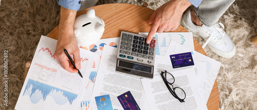 Young man in debt using cal...