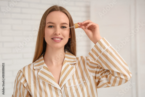 Young woman applying facial...