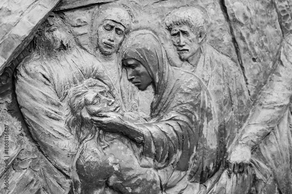 Fototapeta premium Station XIV: Jesus is laid in the tomb. The Way of the Cross on Mount Križevac (the Cross Mountain) in Medjugorje.