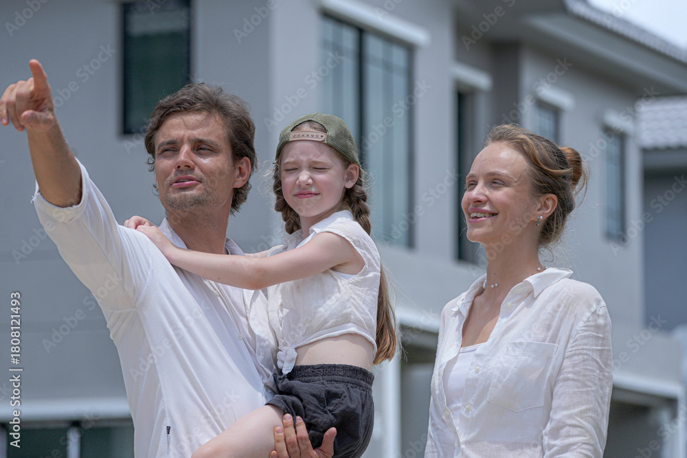 Naklejka premium A beautiful moment of family affection as loving parents kiss their happy daughter's cheeks. The family shares a tender embrace, symbolizing love, security, and a happy home life.