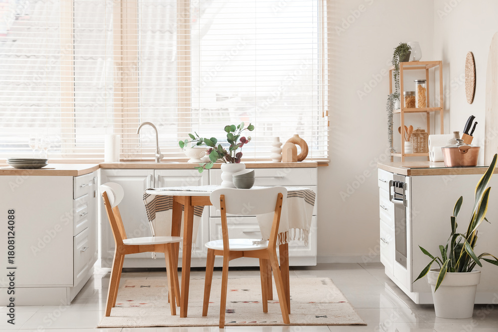 Fototapeta premium Interior of kitchen with dining table, counters and shelf unit