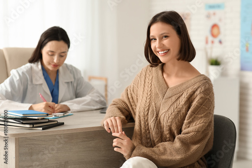 Happy young female doctor w...