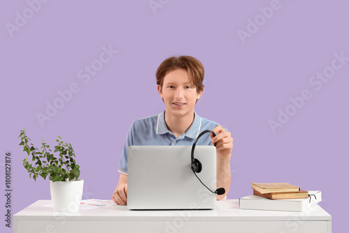 Teenage boy with laptop and...