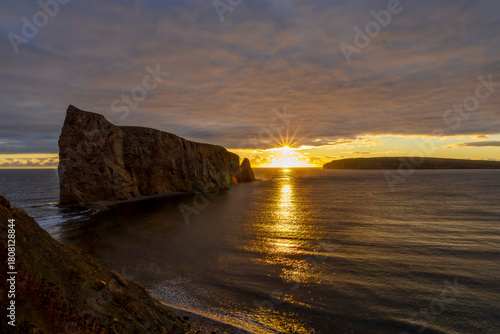 Breathtaking sunrise over Perce Rock, Gaspe Peninsula, Quebec. Captured in stunning morning light, this iconic landmark offers a serene and picturesque view.