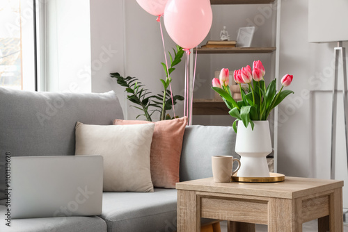 Vase with tulips and cup of...
