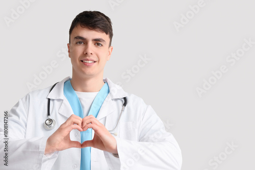 Male doctor making heart ge...