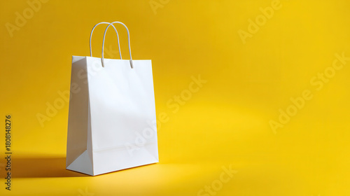 Minimalist white paper shopping bag on bright yellow background