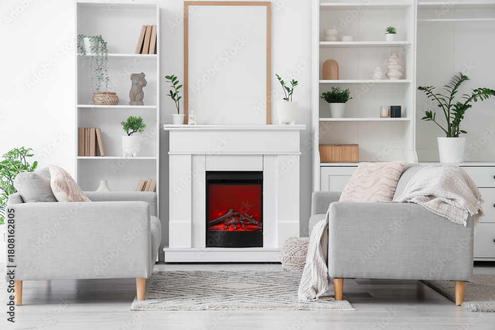 Fototapeta premium Fireplace and sofas in interior of light living room